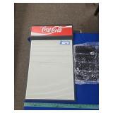 Coca Cola sign with letters and numbers