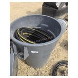 Garbage can with garden hose