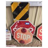 2 stop signs and caution sign
