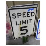 2 metal Speed Limit signs