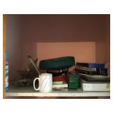 Candles basket and glassware on shelf in closet