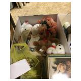 Box of stuffed animals and plate stands
