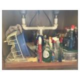 Cleaning supplies and dish drainer in cabinet