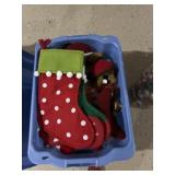 Tote of Christmas decorations bears stockings and