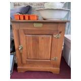 White clad ice box style cabinet