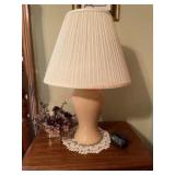Table lamp with doily, faux plant and clock