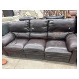 Damaged brown leather sofa with reclining ends