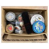 Box of shoe polish and shoe shine brush