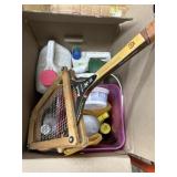 Tennis racket and box of partial cans of weed