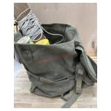 Green duffle bag of baseballs and tennis balls