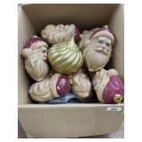 Box of Santa head Christmas ornaments