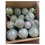 Box of  large green Christmas ornaments