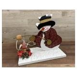 Wood cut out snowman roasting marshmallow