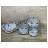 White Ceramic Cookware Set with Wear and Bent Lid