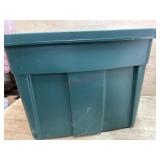 Green tote of blankets and misc. pictures