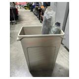 Trash can with roll of plastic and pipe