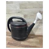 Black plastic watering can