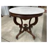 Victorian style oval parlor table with marble top