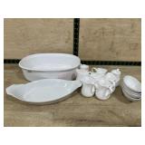 White serving bowl with small cream pitchers and