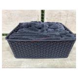 Tote of black hand towels and wash rags