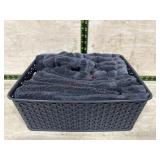 Tote of black hand towels and wash rags