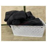 Tote of black hand towels and wash rags