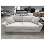White upholstered sofa with throw cushions