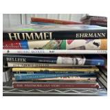 Stack of collectibles and collectors guide books