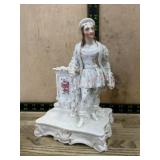 French style porcelain figurine with small flower
