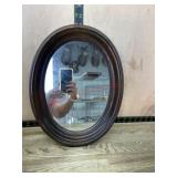 Oval framed wall mirror