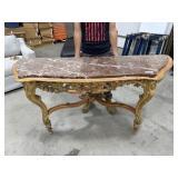 Golden half moon entry table with marble top.