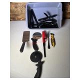 Tub of plastic tongs. Pizza cutters. Spatula.