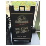 A frame sidewalk display sign.