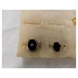 Two 10k black onyx rings: diamond in center, size Two 10k black onyx rings: diamond in center, size