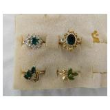 Non gold rings w/ green sets, around size 6