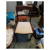 Padded chair with flower etched on wood Padded chair with flower etched on wood