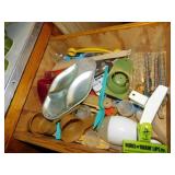 Drawer contents of kitchen items: egg separator -