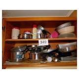 Contents of cabinet above stove: various kitchen