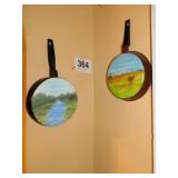 2 skillets with painting on bottom - one saw 2 skillets with painting on bottom - one saw