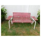 Red and white wood and metal glider with attached Red and white wood and metal glider with attached