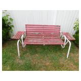 Red and white wood and metal glider with attached