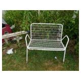 White metal bench (located near church) White metal bench (located near church)