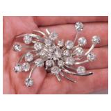 Emmons open wheel swirl rhinestone brooch