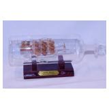 Blown glass Santa Maria ship in glass bottle on
