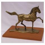 Vintage solid brass horse statue on wood base,