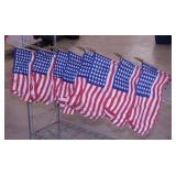 10 American flags on wooden poles