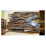 Drill bits including concrete