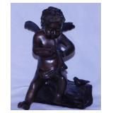 Signed Komart cast bronze cherub sculpture w/ horn