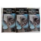 3 mock security cameras in boxes, swivels & light