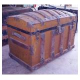 Nice antique camel back steamer trunk on rollers
